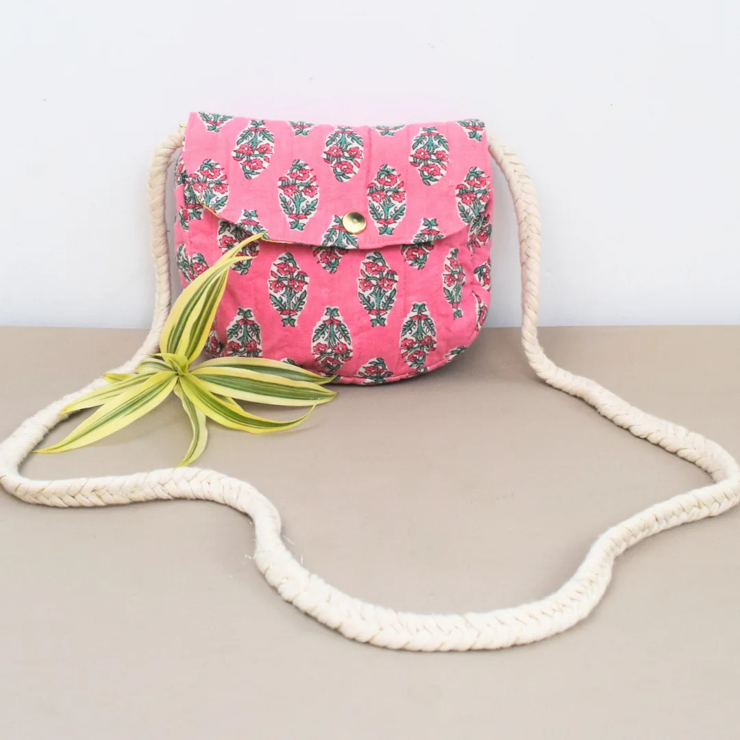 Handcrafted pink floral block print sling bag with braided cotton rope strap and button flap closure